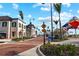 Street view showing sidewalk with pedestrian crossing sign and colorful outdoor art structures at 1678 Quail Lake Dr, Venice, FL 34293