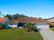 Single-story home with terracotta tile roof and landscaped lawn at 1678 Quail Lake Dr, Venice, FL 34293