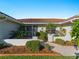 The attractive home is surrounded by gorgeous landscaping and mulch with a white brick retaining wall at 1678 Quail Lake Dr, Venice, FL 34293