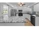 Bright kitchen featuring stainless steel appliances, granite countertops, and white cabinetry at 1678 Quail Lake Dr, Venice, FL 34293
