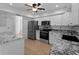 Updated kitchen featuring stainless steel appliances, granite countertops, and modern finishes at 1678 Quail Lake Dr, Venice, FL 34293