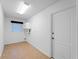 Bright laundry room features a window, upper cabinets, and tile flooring at 1678 Quail Lake Dr, Venice, FL 34293