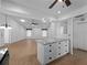 Open-concept living space with granite-top island and a seamless flow throughout the home at 1678 Quail Lake Dr, Venice, FL 34293