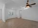 Living room with neutral tile flooring and decorative glass paneled front doors at 1678 Quail Lake Dr, Venice, FL 34293