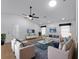 Spacious living room featuring vaulted ceilings, ceiling fans, and stylish neutral furnishings at 1678 Quail Lake Dr, Venice, FL 34293