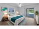 Bright bedroom with ceiling fan, white furniture, and sliding door to the pool area at 1678 Quail Lake Dr, Venice, FL 34293