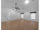 Spacious main bedroom featuring tile floors, three windows, and a ceiling fan at 1678 Quail Lake Dr, Venice, FL 34293