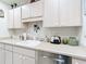 Kitchen boasts white cabinets, a built-in microwave, and a dishwasher at 200 The Esplanade N # A7, Venice, FL 34285