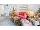 Relaxing living room with coral sofa and floral armchair at 200 The Esplanade N # A7, Venice, FL 34285
