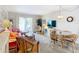 Living area features coral sofa and wicker chairs near dining area at 200 The Esplanade N # A7, Venice, FL 34285