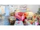 Cozy living room with coral sofa and floral armchair near dining area at 200 The Esplanade N # A7, Venice, FL 34285