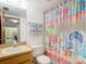 Clean bathroom with shower/tub, vanity, and beach-themed decor at 21405 Olean Blvd # 404, Port Charlotte, FL 33952