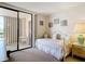 Bedroom with daybed, dresser, and access to a private balcony at 21405 Olean Blvd # 404, Port Charlotte, FL 33952