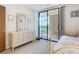 Bedroom with a dresser and sliding glass doors leading to a balcony at 21405 Olean Blvd # 404, Port Charlotte, FL 33952