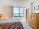 Bedroom with dresser and sliding glass doors opening onto a balcony at 21405 Olean Blvd # 404, Port Charlotte, FL 33952