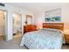 Comfortable bedroom with a dresser, ensuite bathroom, and leafy patterned bedding at 21405 Olean Blvd # 404, Port Charlotte, FL 33952