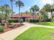 Inviting community clubhouse entrance with lush landscaping at 21405 Olean Blvd # 404, Port Charlotte, FL 33952