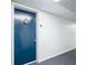 Condo hallway with blue apartment door at 21405 Olean Blvd # 404, Port Charlotte, FL 33952