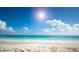 Sunny beach scene with clear water and blue sky at 2260 Stickney Point Rd # 303, Sarasota, FL 34231