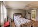 Bedroom with floral bedding, hardwood floors, and ceiling fan at 2260 Stickney Point Rd # 303, Sarasota, FL 34231