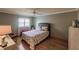 Bedroom with floral bedding, hardwood floors, and a ceiling fan at 2260 Stickney Point Rd # 303, Sarasota, FL 34231