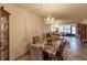 Charming dining area with a granite-top table and chandelier at 2260 Stickney Point Rd # 303, Sarasota, FL 34231