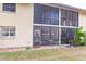 Back exterior view showing patio and screened enclosure at 2260 Stickney Point Rd # 303, Sarasota, FL 34231