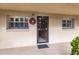 Inviting condo entry with a wreath and neutral color scheme at 2260 Stickney Point Rd # 303, Sarasota, FL 34231