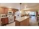 Well-equipped kitchen featuring wood cabinets and an island at 2260 Stickney Point Rd # 303, Sarasota, FL 34231