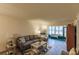 Cozy living room with grey sofa and access to a lanai at 2260 Stickney Point Rd # 303, Sarasota, FL 34231
