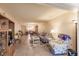 Bright living room with tile floors, sofa, and view into the kitchen and dining area at 2260 Stickney Point Rd # 303, Sarasota, FL 34231