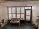 Sunroom features a bench, side table, and large windows with plantation shutters at 2260 Stickney Point Rd # 303, Sarasota, FL 34231