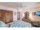 Spacious bedroom featuring a queen bed, built-in shelving, and large closet at 2240 Stickney Point Rd # 213, Sarasota, FL 34231