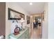 Bright condo entryway with decorative console table and mirror at 2240 Stickney Point Rd # 213, Sarasota, FL 34231