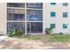 Condo building with private entrance and well-maintained landscaping at 2240 Stickney Point Rd # 213, Sarasota, FL 34231