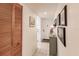 Condo hallway with wood louvered doors and framed artwork at 2240 Stickney Point Rd # 213, Sarasota, FL 34231