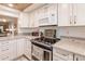 Updated kitchen with white cabinets and granite countertops at 2240 Stickney Point Rd # 213, Sarasota, FL 34231
