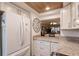 White kitchen cabinets, granite countertops and stainless steel appliances at 2240 Stickney Point Rd # 213, Sarasota, FL 34231