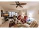 Living room with comfy seating, large TV, and ceiling fan at 2240 Stickney Point Rd # 213, Sarasota, FL 34231