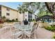 Community patio with table and chairs, near the pool and BBQ at 2240 Stickney Point Rd # 213, Sarasota, FL 34231
