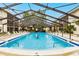 Inviting community pool with screened enclosure and lounge chairs at 2240 Stickney Point Rd # 213, Sarasota, FL 34231