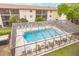 Community pool with many people enjoying a sunny day at 2240 Stickney Point Rd # 213, Sarasota, FL 34231