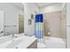 Clean bathroom with a tub and shower, a modern vanity, and contemporary fixtures for a fresh look at 232 Benedetto Ct, Nokomis, FL 34275