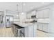 Modern kitchen with stainless steel appliances, a large center island, and stylish gray cabinetry at 232 Benedetto Ct, Nokomis, FL 34275