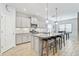 Bright eat-in kitchen featuring stainless appliances, a granite island, and stylish pendant lighting at 232 Benedetto Ct, Nokomis, FL 34275