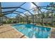 Inviting pool with lounge chairs and a relaxing view of the yard and landscaping at 232 Benedetto Ct, Nokomis, FL 34275