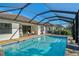 Beautiful screened-in pool with brick patio and views of well-maintained landscaping at 232 Benedetto Ct, Nokomis, FL 34275