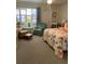 Spacious bedroom with two armchairs and a bed at 244 Saint Augustine Ave # 104, Venice, FL 34285