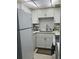 Well-equipped kitchen featuring white cabinets and modern appliances at 244 Saint Augustine Ave # 104, Venice, FL 34285