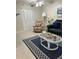 Living area with a floral armchair and coffee table at 244 Saint Augustine Ave # 104, Venice, FL 34285